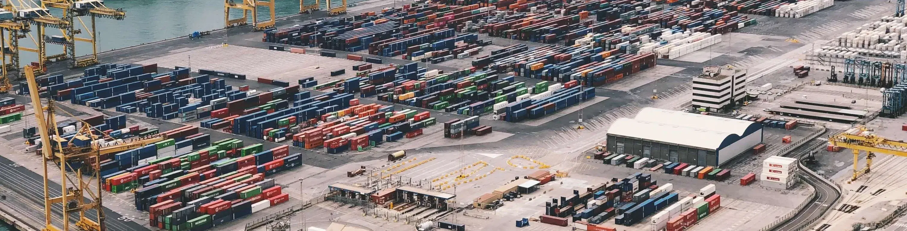 Quay cranes along the waterfront of a container terminal