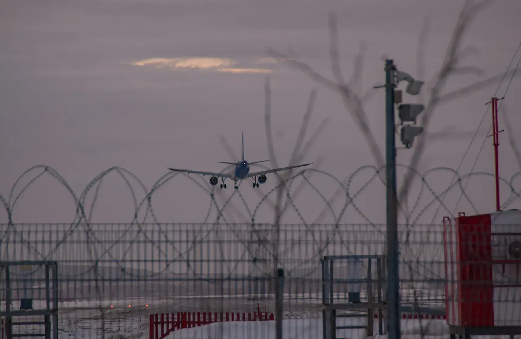 A secured perimeter fence with a camera mast
